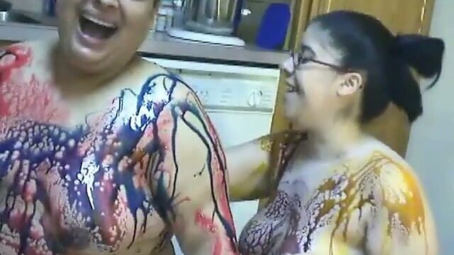 BBW lesbian girls gets messy in chocolate syrup in the kitchen