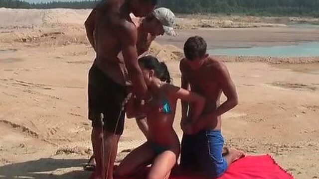 Kinky Russian chick is nailed doggy while sucking meaty cock on a beach