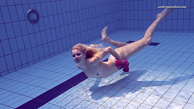 Sport swimming babe Elena Proklova is stripping under the water