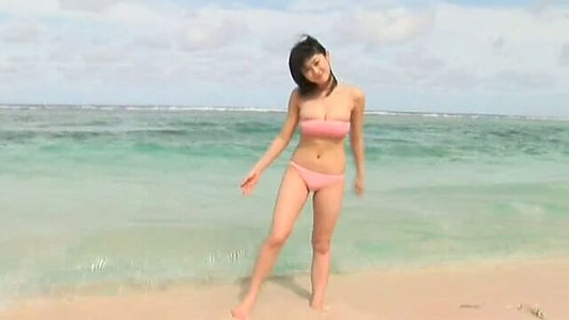 Hungry and horny Mikie Hara plays on a beach showing off her sexy body