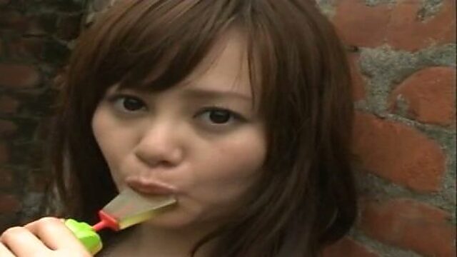 Magnetizing Japanese model Akiko Seo is licking candy seductively
